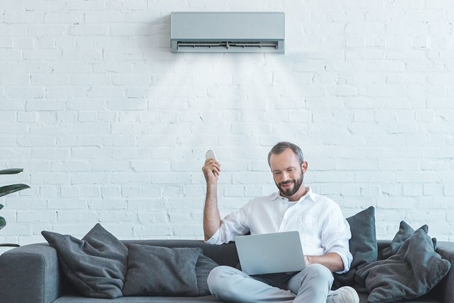 man with ductless system remote
